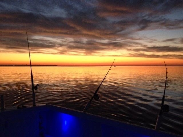 Sunset fishing rods on boat
